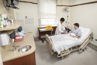 Hospital room with a patient and doctor.